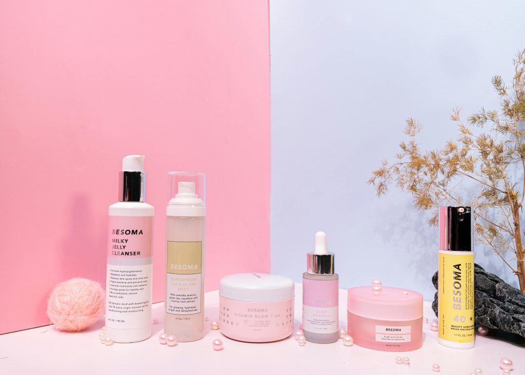 Skincare routine flat lay showing peptide serum paired with moisturizer and sunscreen.